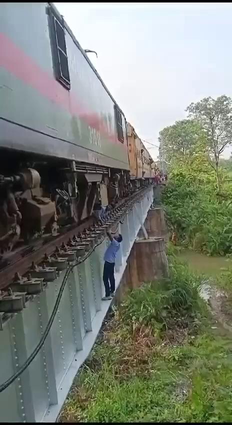 *The incident occurred on June 21, 2024 near Valmiki Nagar Road Station of East Central Railway.* An air leakage from a valve in Train No. 05497 Narkatiaganj - Gorakhpur Express after it left from VKNR (East Central Railway), made the train motionless. The incident occurred over a naked bridge. Loco Pilot Ajay Yadav and Co-loco Pilot Ranjeet Kumar took great efforts to close the leakage as could be seen from the video. He literally crawled on his chest and stomach to reach the site, repaired and returned. His colleague was hanging over the bridge all the time watching. What dedication ! Admirable ! *Salute to our Loco Pilots.....