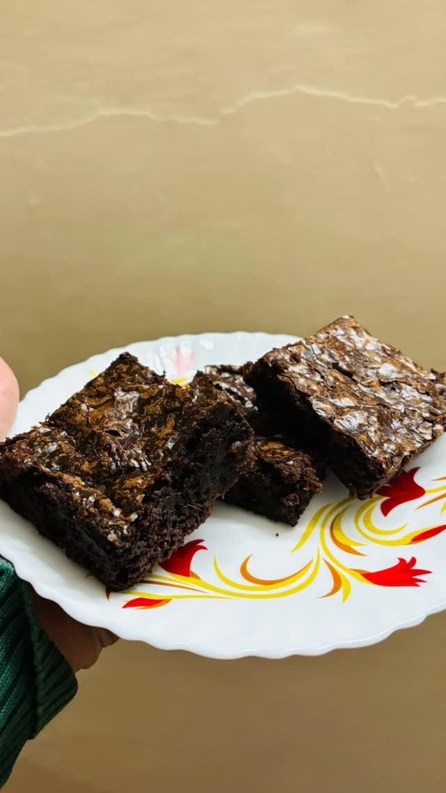 "Indulge in the ultimate winter comfort with a warm 🔥, gooey 🍪 brownie with the ideal crinkle top which shows that the brownies are baked to perfection🤩 
The flawless  blend of chocolatey 🍫goodness and cozy ❤️vibes to melt away the chill of the season
You can order with us and enjoy the most decadent brownies